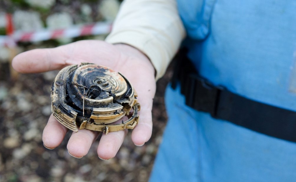 A destroyed mine in the hand of a HI clearance expert in Lebanon. ; }}
